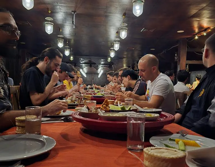 Sprint participants sharing dinner at a long table in a restaurant